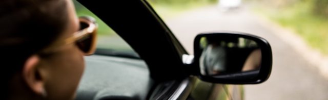 A women staring out the window of a car