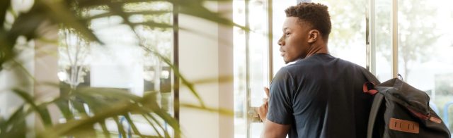A student walking out of a building