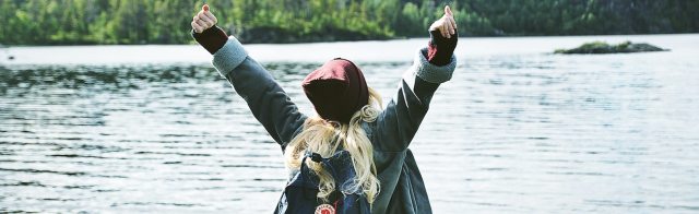 A woman standing by a lake