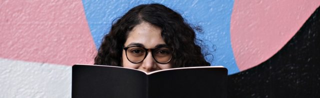 A student holding a textbook