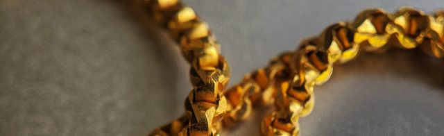 A gold chain laying on a table